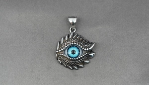 Macro view of blue evil eye dragon pendant with detailed scales in silver steel