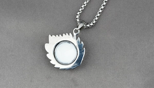 Detail view of silver evil eye pendant with jagged edges on a sturdy box chain
