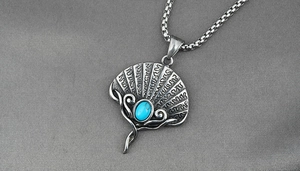 Detail of vintage fan pendant necklace with turquoise stone inlay on silver steel chain