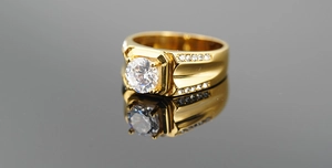 Macro shot of men's gold titanium ring with a large zircon and side stone setting