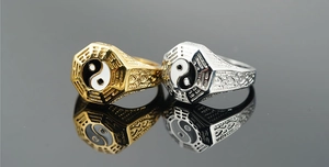 Detail showing gold and silver Tai Chi rings with Ba Gua engravings and hollowed side patterns