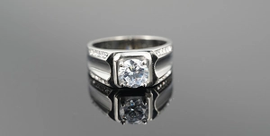 Detailed view of men's titanium steel ring with round brilliant cut center stone
