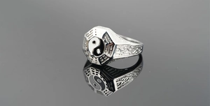 Macro view of silver Tai Chi ring with Bagua symbols and ornate side filigree