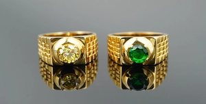 Close-up of gold titanium steel rings featuring square texture and vibrant gemstones