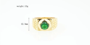 Detail view of gold titanium ring with green gemstone showing 12.3mm height and 13g weight