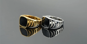 Macro shot of vintage gold and silver signet rings with black inlay and carved details