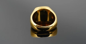 Polished golden stainless steel ring showcasing the thick band and mirror finish