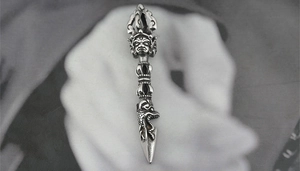 Detailed close-up of a retro titanium steel Buddhist pendant with a dragon head design