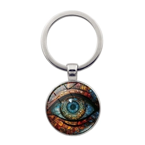 Macro view of a metallic evil eye keychain pendant with vibrant colorful glass eye pattern