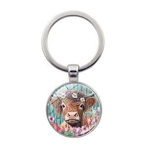Silver metal keychain with highland cow floral illustration pendant on white background