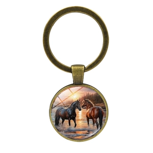 Vintage bronze round horse keychain pendant with artistic sunset scene on white background