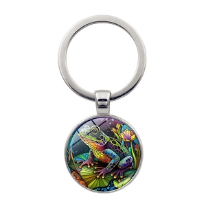 Macro shot of silver metal keychain pendant featuring a colorful frog art illustration