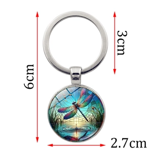 Artistic dragonfly pond scene keychain with round glass pendant and metal ring charm