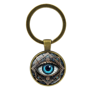 Close-up of bronze mandala evil eye keychain with artistic blue eye glass dome pendant