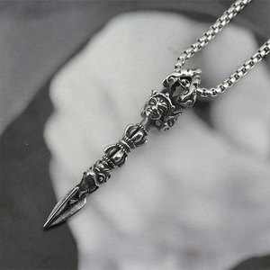 Retro stainless steel Tibetan Vajra pestle necklace for men on grey stone background