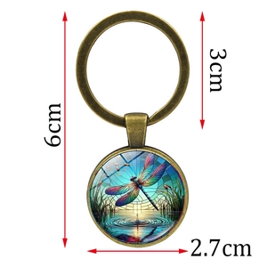 Artistic dragonfly pattern keychain in bronze metal frame with dimensions 6cm total length