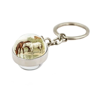 Detail of horse painting glass dome keychain with polished silver metal finish