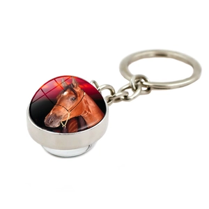 Detail view of the silver metal keychain featuring a double-sided horse head glass cabochon