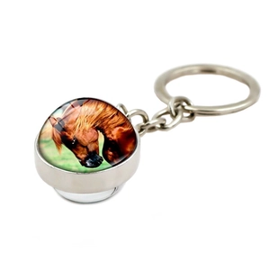 Detail view of the silver metal keychain featuring a double-sided horse crystal glass ball