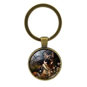 Vintage bronze German Shepherd keychain pendant with moonlight forest art on white background