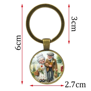 Vintage bronze keychain with romantic elderly couple illustration and dimensions 6cm x 3cm