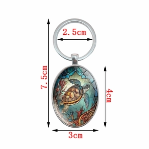 Oval keychain with turtle pendant, silver metal ring, turquoise sea turtle design, 7.5cm long