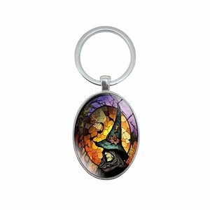 Oval keychain with stained glass witch portrait, moon, and bats on silver metal ring
