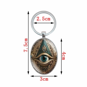 Oval Horus Eye keychain with steampunk gear pattern and dimensions of 7.5cm x 3cm