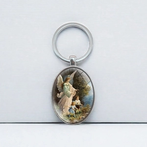Guardian Angel oval metal keychain featuring a vintage religious illustration in silver