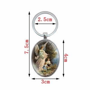 Oval silver metal guardian angel keychain with vintage art scene showing children