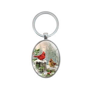 Oval cardinal bird keychain with red birds on snowy branch in silver metal frame