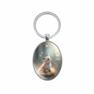 Oval metal keychain with fox and butterfly illustration on white background