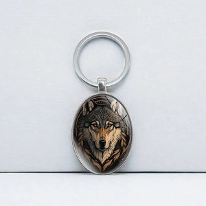 Oval wolf head pendant keychain in silver metal finish with polished glass cabochon