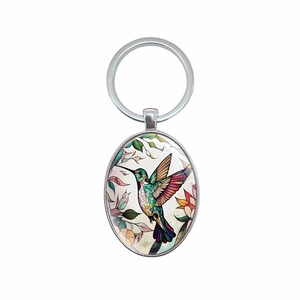 Oval silver metal keychain with colorful hummingbird and floral art pattern design