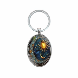 Oval metal keychain with artistic sun and moon motif in bright colorful stained glass style