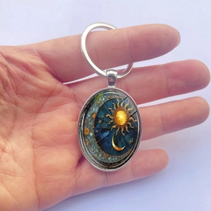 Silver oval keychain with sun and moon pattern pendant for car keys and bags