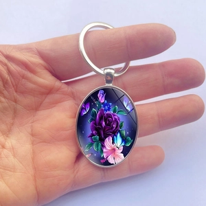 Elegant oval keychain with purple rose and blue butterfly pendant on a silver metal ring