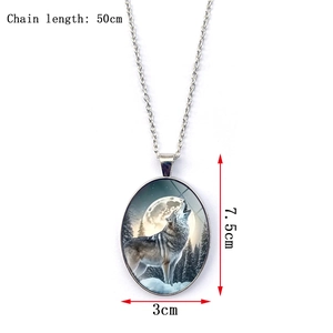 Detail view of oval howling wolf moon pendant showing 50cm chain and 7.5x3cm dimensions