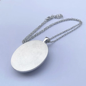 Elegant silver tree of life oval pendant necklace with a honeycomb textured back design