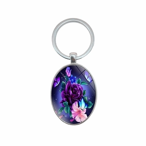 Elegant oval keychain with purple roses and blue butterflies on a white background