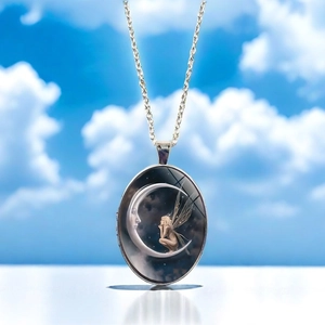 Detailed close-up of the moon goddess fairy oval pendant necklace in silver finish