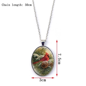 Detail view of oval cardinal bird pendant with dimensions 7.5cm x 3cm and 50cm chain
