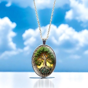 Detail of vintage Tree of Life oval pendant with intricate baroque pattern and silver chain