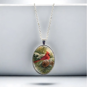 Vintage cardinal bird oval pendant necklace with red cardinal on snowy pine branch