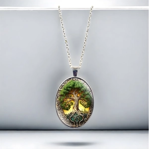 Vintage oval Tree of Life pendant necklace with silver finish and green leaf design