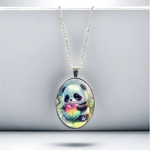 Detail of silver chain necklace featuring an oval panda pendant holding a rainbow heart