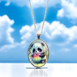 Detailed macro of oval panda pendant with rainbow heart on silver necklace