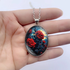 Oval pendant necklace with red rose and starry sky art illustration on white background