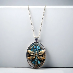 Oval dragonfly pendant necklace with stained glass style art on a silver chain