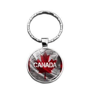 Macro view of Canada flag key ring with maple leaf design and polished glass dome cover